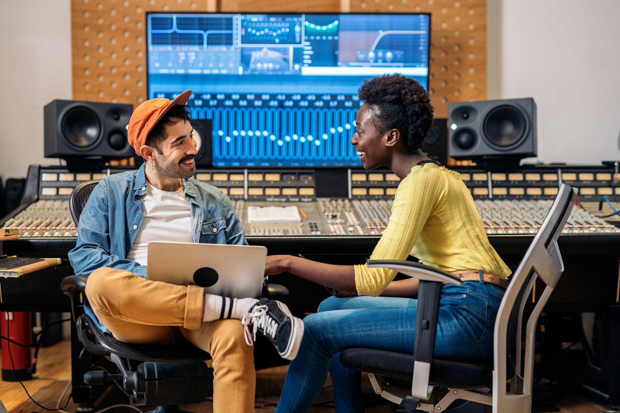 Artist and production team discussing a music or audio project
