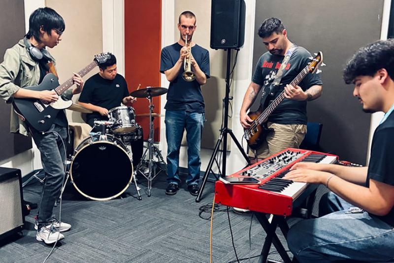 Musicians rehearsing and practising together in a music room